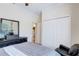 Bedroom featuring wood floors, a black dresser, and a closet with bifold doors at 2827 Moonstone Bnd, Kissimmee, FL 34758