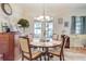 Charming dining area with round table and chairs with natural light entering at 2827 Moonstone Bnd, Kissimmee, FL 34758