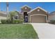 Charming home featuring a two-car garage, well-manicured lawn and appealing curb appeal at 2827 Moonstone Bnd, Kissimmee, FL 34758