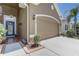 Exterior of home with a two-car garage and tiled front porch at 2827 Moonstone Bnd, Kissimmee, FL 34758