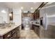 Modern kitchen with stainless steel appliances and dark wood cabinets and tiled flooring at 2827 Moonstone Bnd, Kissimmee, FL 34758
