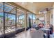 Relaxing screened patio with comfortable seating, overhead fan, and view of the landscaped yard at 2827 Moonstone Bnd, Kissimmee, FL 34758