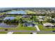 An aerial view shows the property's neighborhood surrounded by lakes, trees, and neighboring homes at 2984 Monica Ter, Kissimmee, FL 34744