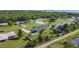 An aerial view of the property shows its beautiful location near a lake and surrounded by lush greenery and neighboring homes at 2984 Monica Ter, Kissimmee, FL 34744