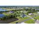 An aerial view of the property shows its beautiful location near a lake, golf course, and neighboring homes at 2984 Monica Ter, Kissimmee, FL 34744