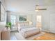 Inviting bedroom with soft bedding, a ceiling fan, and ensuite bathroom entrance at 2984 Monica Ter, Kissimmee, FL 34744