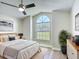 Bright bedroom with large window, ceiling fan, wood floors, and neutral decor at 2984 Monica Ter, Kissimmee, FL 34744