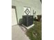Exterior of home showing modern A/C unit, side of garage, and trash receptacles at 2984 Monica Ter, Kissimmee, FL 34744