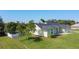 Lovely exterior with a lush lawn, mature trees, and a charming white picket fence at 2984 Monica Ter, Kissimmee, FL 34744