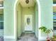Charming front entry featuring a white door with decorative glass detail, set in a welcoming arched doorway at 2984 Monica Ter, Kissimmee, FL 34744