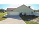 Side garage view featuring a large driveway and a well-maintained exterior at 2984 Monica Ter, Kissimmee, FL 34744
