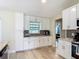 Bright kitchen with white cabinets, granite countertops, stainless steel appliances and stylish backsplash at 2984 Monica Ter, Kissimmee, FL 34744