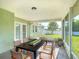 A spacious, screened-in patio includes a dining table with seating and a lovely view of the landscaped backyard at 2984 Monica Ter, Kissimmee, FL 34744