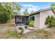 Backyard featuring a screened-in patio, lush greenery, and privacy fence at 314 E Bonnie Trl, Longwood, FL 32750
