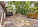 A view of the backyard featuring a screened in porch with a wooden fence line in the distance at 314 E Bonnie Trl, Longwood, FL 32750