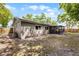 A view of the backyard featuring a screened-in porch and a wooden fence at 314 E Bonnie Trl, Longwood, FL 32750