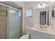 Updated bathroom featuring a tiled shower with glass door, a vanity, and modern fixtures at 314 E Bonnie Trl, Longwood, FL 32750