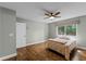 Comfortable bedroom with wood floors, ceiling fan, and natural light from window at 314 E Bonnie Trl, Longwood, FL 32750