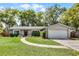 Charming single-story home featuring a well-manicured front yard and attached two-car garage at 314 E Bonnie Trl, Longwood, FL 32750