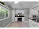Well-lit kitchen with stainless steel gas range, white cabinets, and tiled backsplash at 314 E Bonnie Trl, Longwood, FL 32750