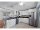 Modern kitchen boasting stainless steel appliances, granite countertops, and white cabinetry at 314 E Bonnie Trl, Longwood, FL 32750