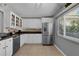 Bright kitchen featuring stainless steel appliances, granite counters, and white cabinetry at 314 E Bonnie Trl, Longwood, FL 32750