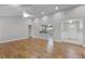 Open-concept living area with hardwood floors, offering views of the kitchen and entryway at 314 E Bonnie Trl, Longwood, FL 32750