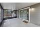 View of screened patio featuring concrete flooring and sliding glass door with neutral-colored exterior at 314 E Bonnie Trl, Longwood, FL 32750