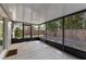 A view of a screened in porch with black frames, concrete flooring, and a view of the fenced in backyard at 314 E Bonnie Trl, Longwood, FL 32750