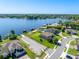 Aerial view of waterfront property with lake access, boat docks, lush lawns, and neighborhood streets nearby at 327 Island Sound Ct, Longwood, FL 32779