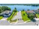 Aerial view of home with a long driveway leading to boat dock on a lake at 327 Island Sound Ct, Longwood, FL 32779