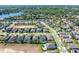 Expansive aerial view showcasing a well-planned community near a picturesque lake and lush green landscape at 327 Island Sound Ct, Longwood, FL 32779
