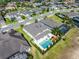 Birds-eye view of a backyard featuring a pool, spa, playground, and lush landscaping within a residential neighborhood at 327 Island Sound Ct, Longwood, FL 32779