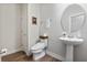 Bathroom features a pedestal sink, round mirror, and commode with bidet seat at 327 Island Sound Ct, Longwood, FL 32779