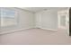 Bedroom featuring neutral carpet, white trim, and a bright window at 327 Island Sound Ct, Longwood, FL 32779
