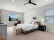Bright bedroom featuring a large window, plush carpet, and a neutral color scheme at 327 Island Sound Ct, Longwood, FL 32779