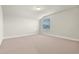 Bright bedroom with neutral carpet, white trim, and a window with blinds at 327 Island Sound Ct, Longwood, FL 32779