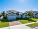 Charming single-Gathering home with a brick driveway, manicured lawn, and palm trees at 327 Island Sound Ct, Longwood, FL 32779