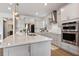 Bright kitchen island with stainless appliances and white countertops at 327 Island Sound Ct, Longwood, FL 32779