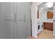 A practical laundry room is equipped with modern appliances, plenty of cabinet space, and elegant hardware at 327 Island Sound Ct, Longwood, FL 32779