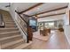 Staircase leads to living room with fireplace and beamed ceiling at 327 Island Sound Ct, Longwood, FL 32779