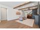 Inviting living room with wood-look tile flooring, beamed ceilings, and neutral decor at 327 Island Sound Ct, Longwood, FL 32779