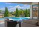 View of a luxurious in-ground pool with waterfall feature and outdoor seating area at 327 Island Sound Ct, Longwood, FL 32779