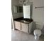 Bathroom features a vanity with granite countertops, a large mirror, and a white toilet at 3344 Corona Village Way # 205, Orlando, FL 32835