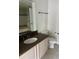 This bathroom features a large vanity with granite countertops and tile flooring at 3344 Corona Village Way # 205, Orlando, FL 32835