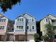 Three-story condo building with attached garages and colorful exterior paint at 3344 Corona Village Way # 205, Orlando, FL 32835