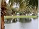Gazebo by the lake on a property with mature trees and lush landscaping at 3344 Corona Village Way # 205, Orlando, FL 32835