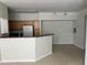 Kitchen featuring tile flooring, stainless steel appliances, and granite counters at 3344 Corona Village Way # 205, Orlando, FL 32835