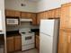 Kitchen featuring wooden cabinets and appliances with plenty of natural light at 3344 Corona Village Way # 205, Orlando, FL 32835