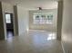Spacious living room featuring tile flooring, a ceiling fan, and lots of sunlight at 3344 Corona Village Way # 205, Orlando, FL 32835